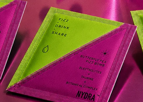 Close on the NYDRA sachet showing the diagonal split between both chambers